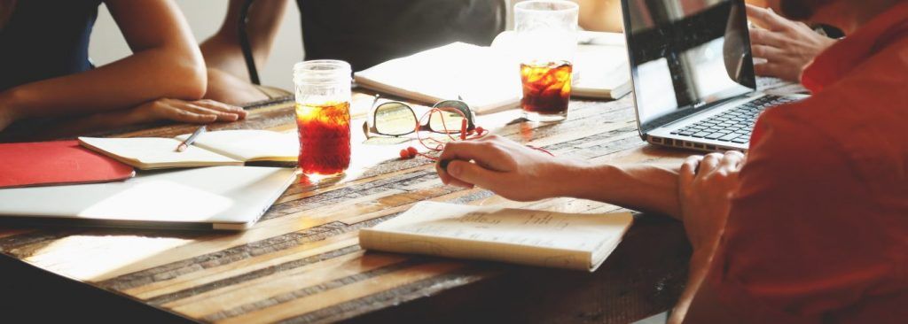 People in discussion across desk in office