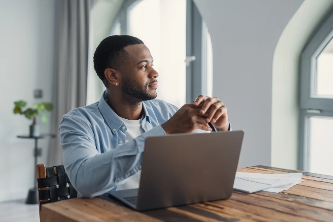 woman working in home office with two screens