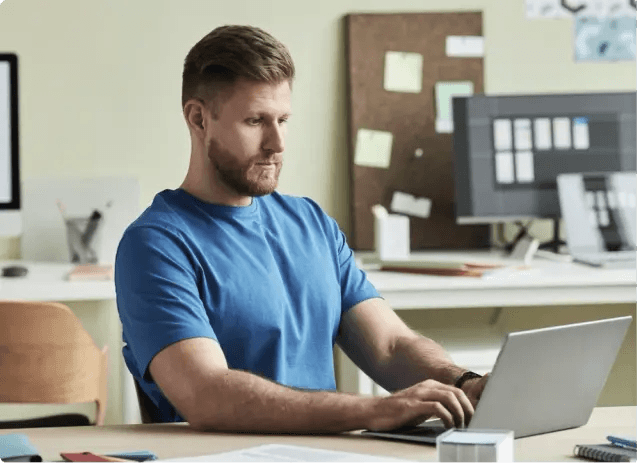 Senior sales team member working on laptop